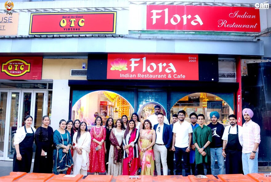 The family and workers from Flora Indian Restaurant posing out the front of their venue.