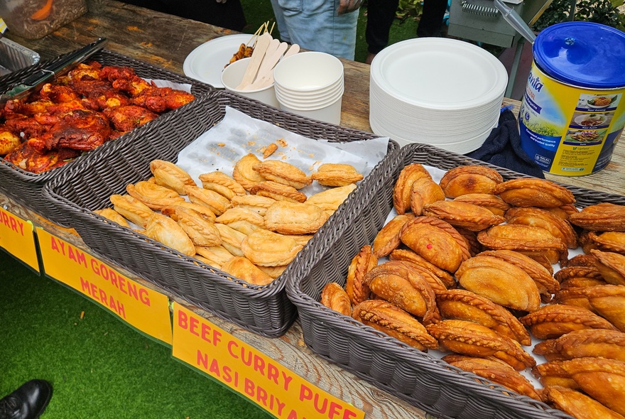 Boxes of fried snacks on a trestle table.