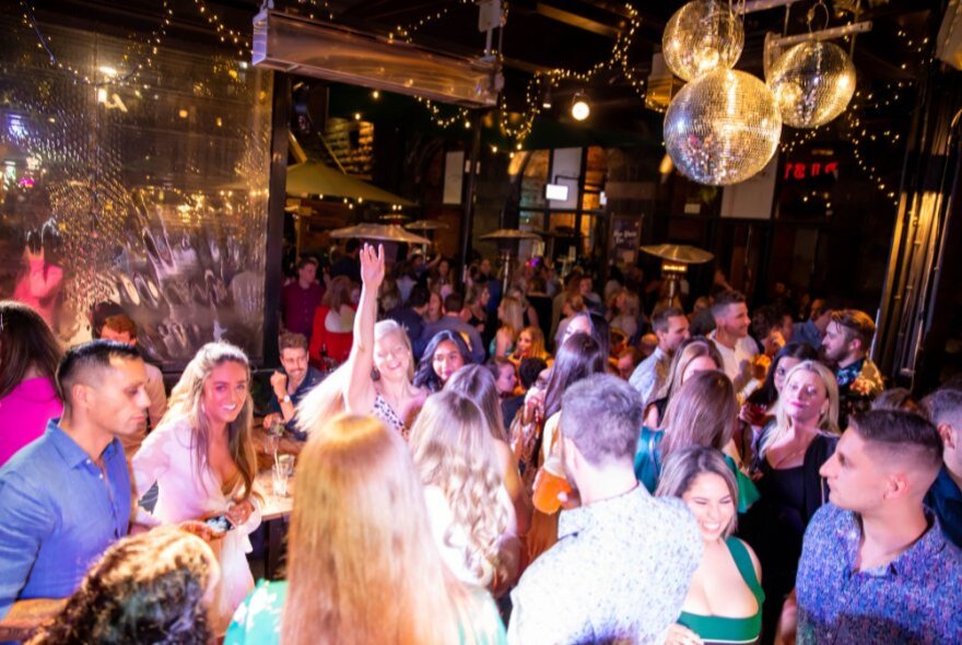 People dancing and enjoying themselves at a New Year's Eve party at Riverland Bar.