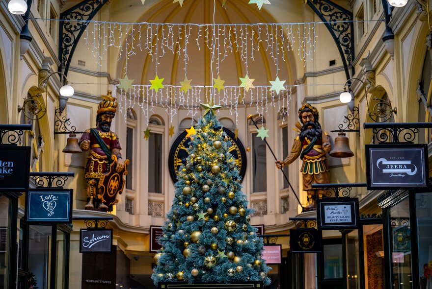 A Christmas tree and lights in a heritage shopping arcade.