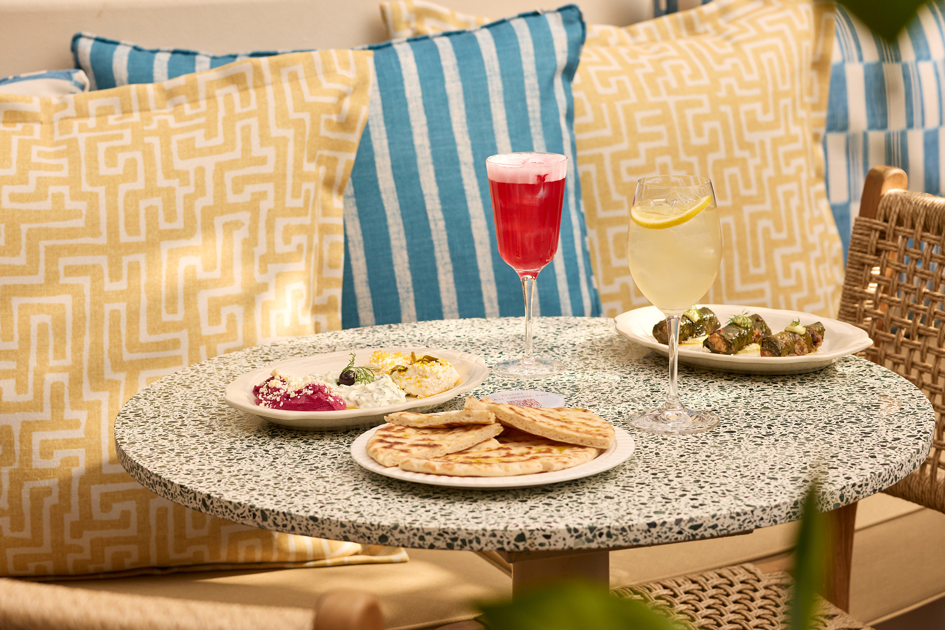 A table with Greek tapas and cocktails.