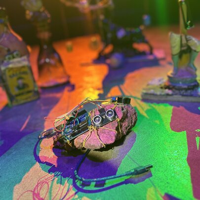 An artwork that features discarded electronic components resembling a robotic creature, part of an exhibition at Science Gallery.