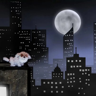 A fluffy dog on top of a building with a fake skyline in the background of skyscrapers and a large moon. 