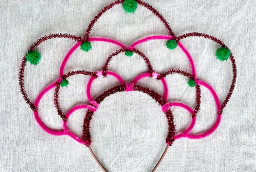 A headband with coloured pipe cleaners to make a cute crown.