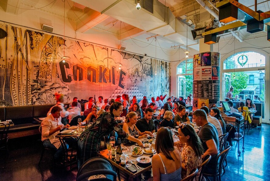 Interior of Cookie restaurant showing many patrons eating at tables.