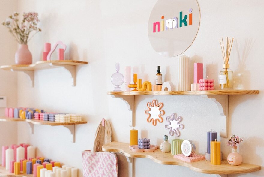 A shop with shelves filled with candles and ceramics.