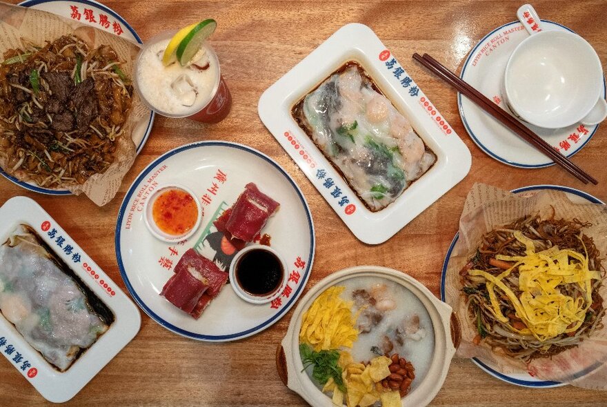 Looking down at a selection of Cantonese dishes on a table in a restaurant.