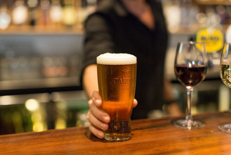 Barman serving a pint of beer.