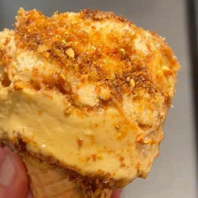 Close up of tiramisu ice cream in a cone.