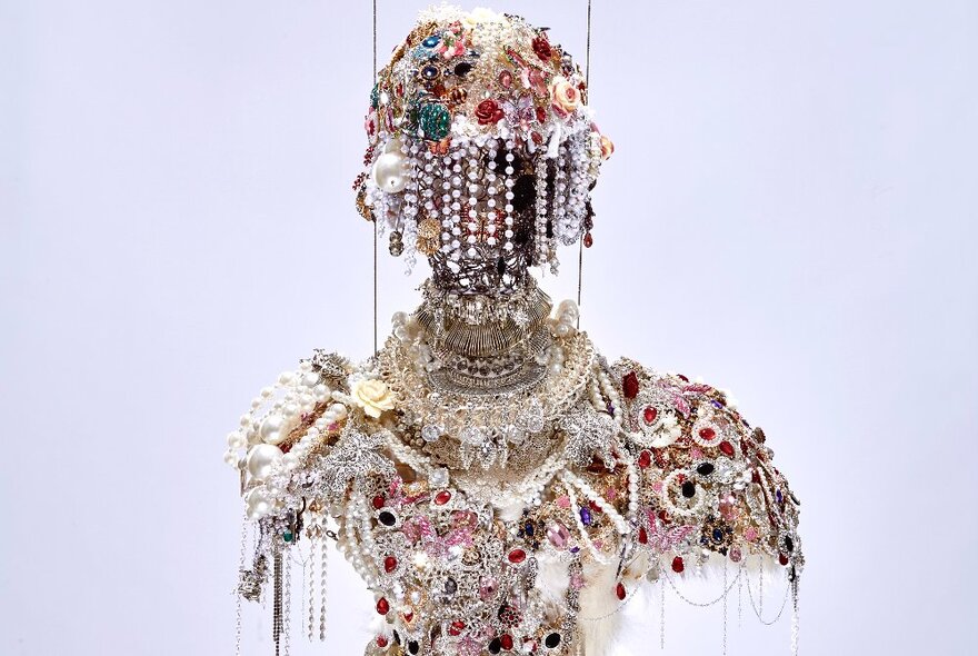Jewelled sculpture of head and torso.