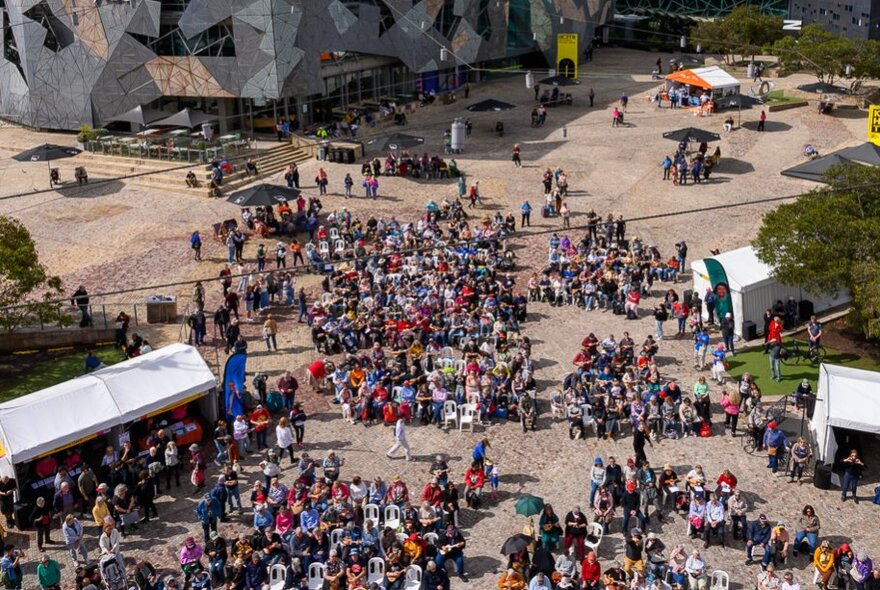 A crowd of people at Melbourne's Fed Square seen from above.