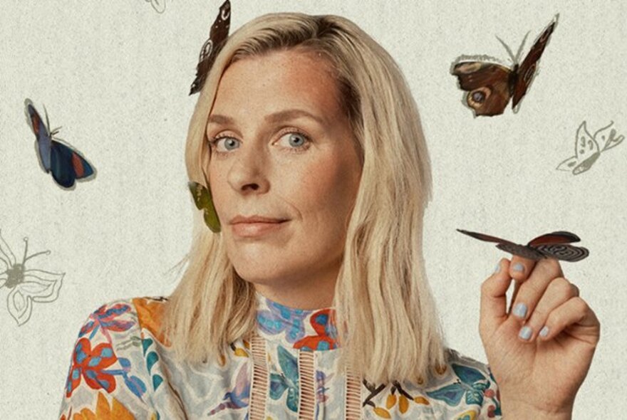 Comedian Sara Pascoe looking bemused, head turned slightly sideways, with illustrated butterflies fluttering around her and one on her hand. 