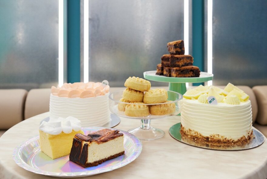 A table with cakes and cookies on it