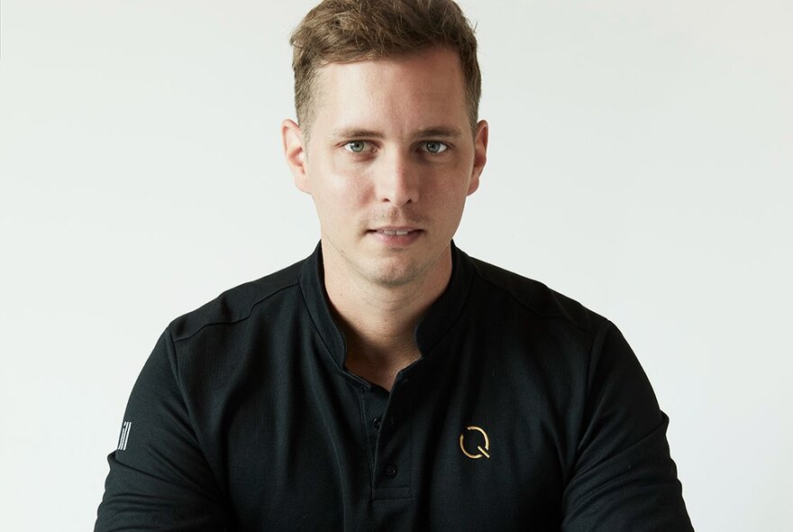 Chef Quentin Zerr in black looking straight ahead, expressionless.
