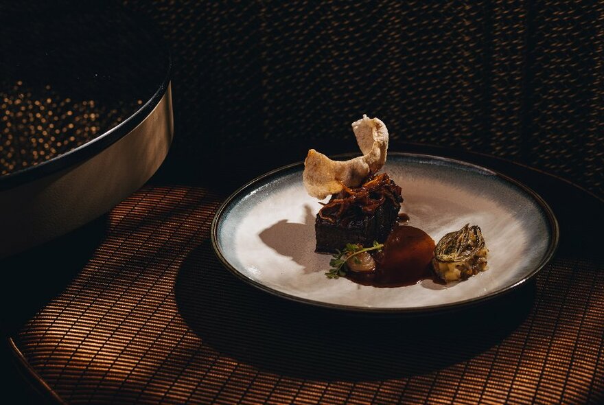 Artfully arranged food on a white dinner plate.