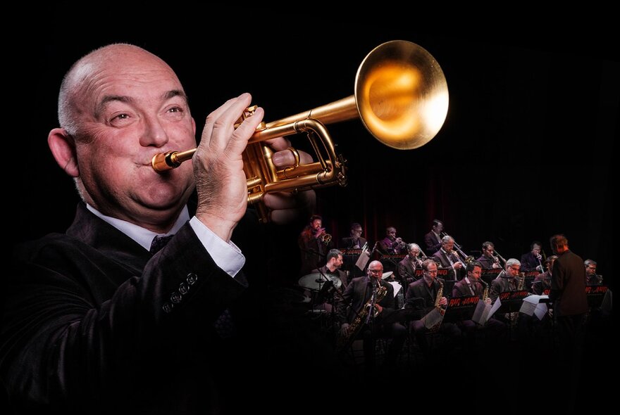 Trumpeter James Morrison playing with a big band far away in the background. 