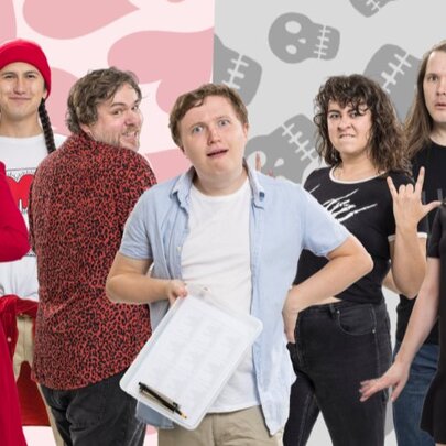 A group of seven performers - a red team, a black team and a neutral person in the middle with a clipboard. 