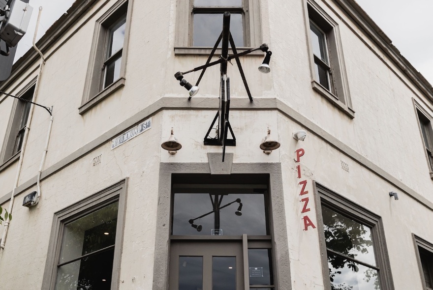 The exterior of D.O.C Pizza & Mozzarella restaurant in Carlton, showing a typical Victorian-era corner building.