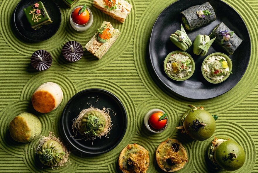 Matcha-themed teatime treats on a matcha green background. 