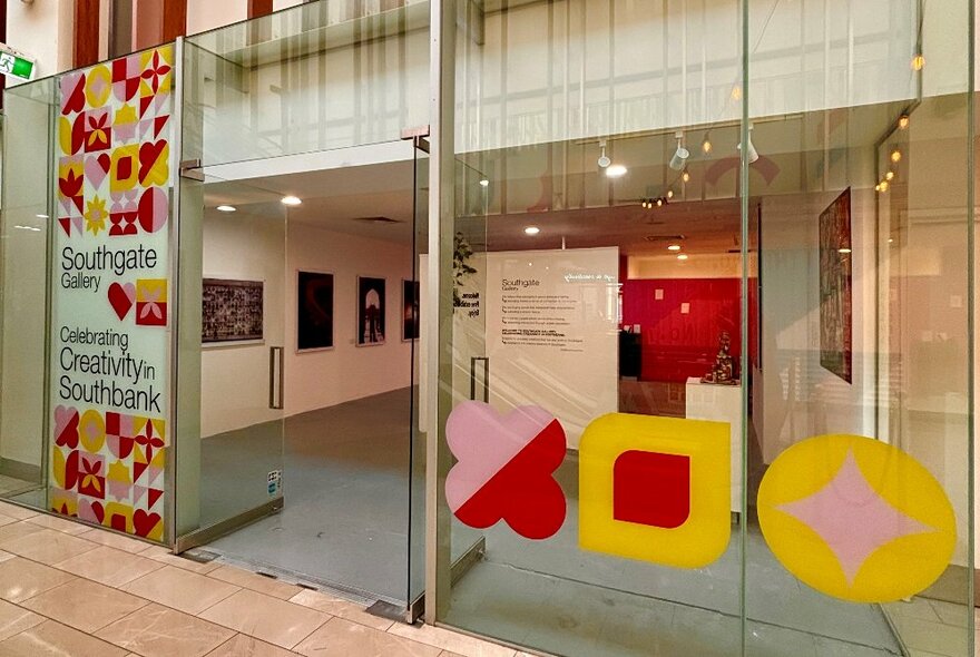 The exterior of Southbank Gallery with coloured shapes on the glass doors. 