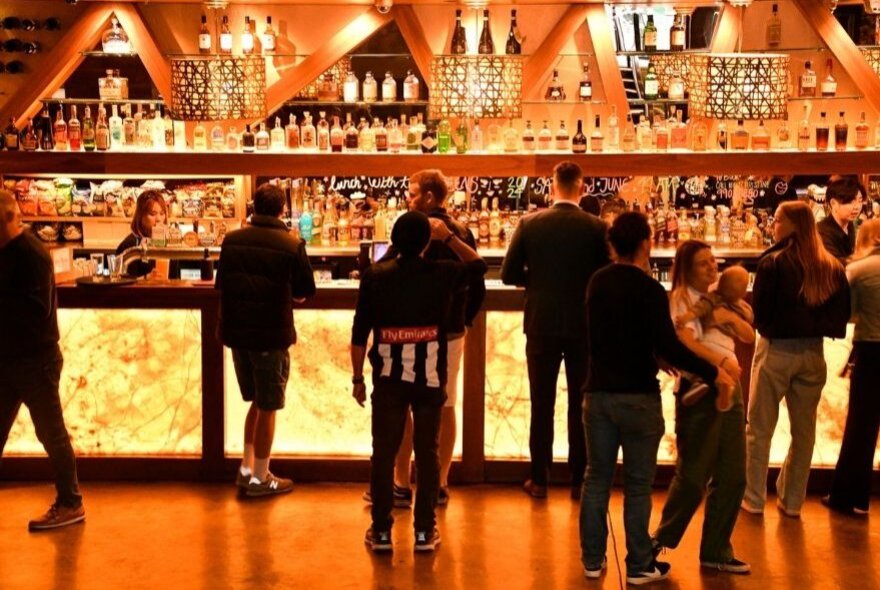 People lined up at the bar at the Mail Exchange Hotel.