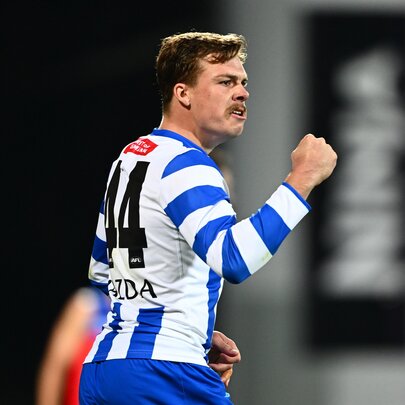 A North Melbourne AFL player making a fist during a game.