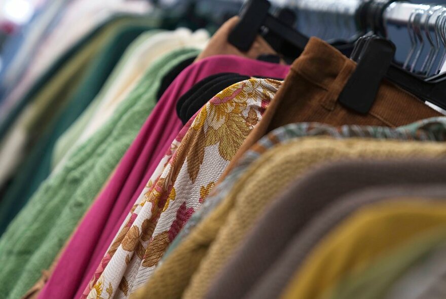 A row of clothing on hangers. 