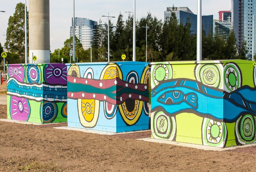 Colourful Aboriginal mural paintings on electrical boxes. 