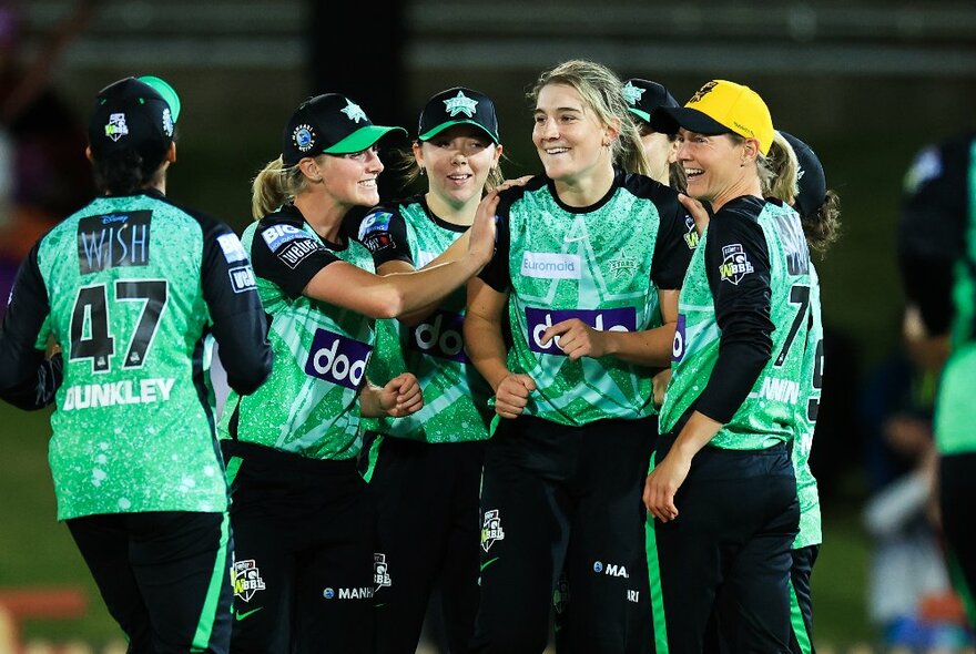 Players from the Melbourne Stars WBBL team wearing green and black uniforms.