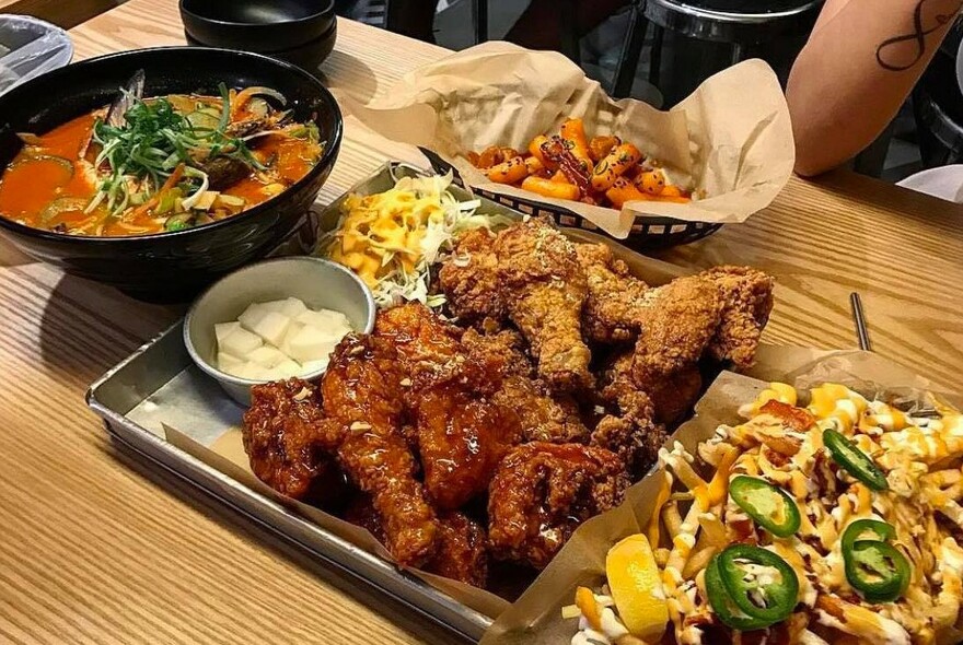 Platter with chicken, salads and dips.