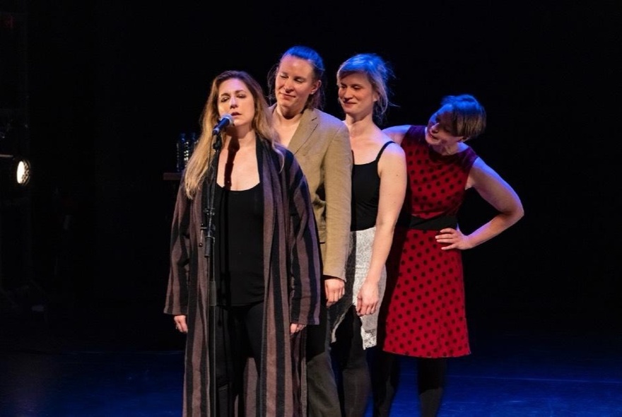 Four impro performers on a stage.