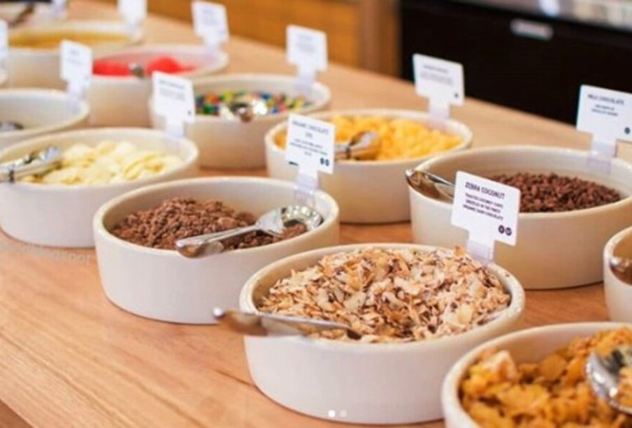 Bowls of toppings at a dessert bar