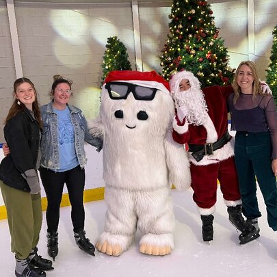 Ice skaters with Santa and a snow character.