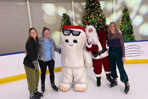 Ice skaters with Santa and a snow character.