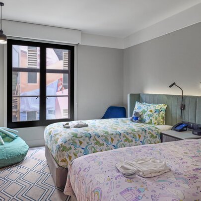 A hotel room with kids beds and toys.