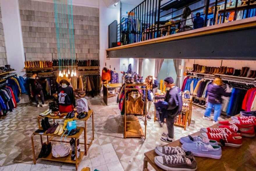 A two-storey vintage store with racks of clothing, shoes and accessories.