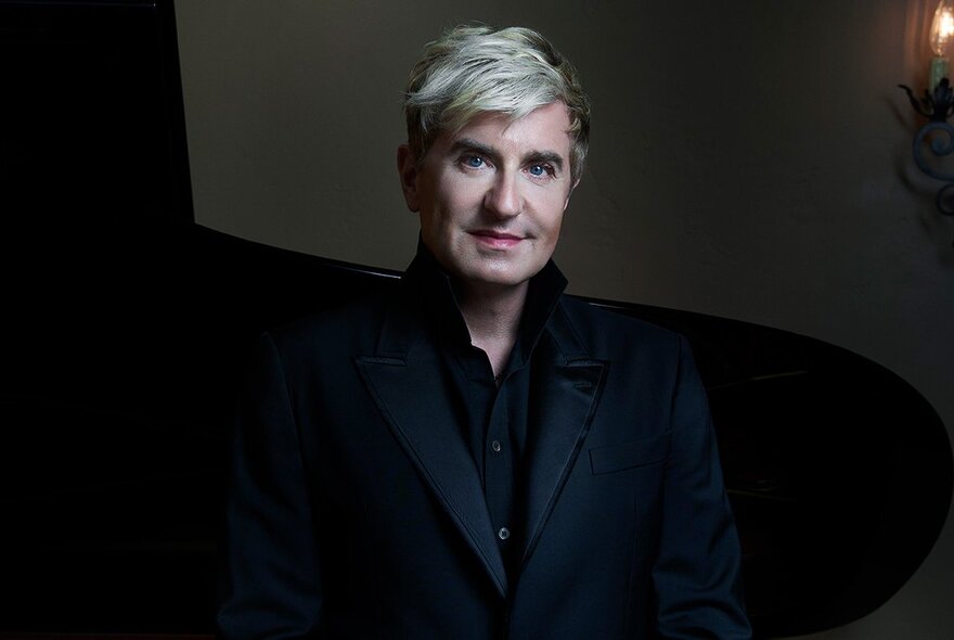 MSO Chief Conductor Jaime Martín in a darkened space, smiling confidently. 