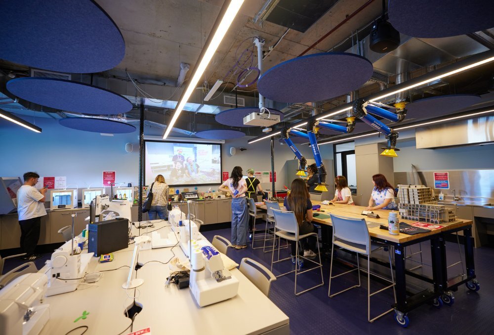 A studio with people using craft equipment.