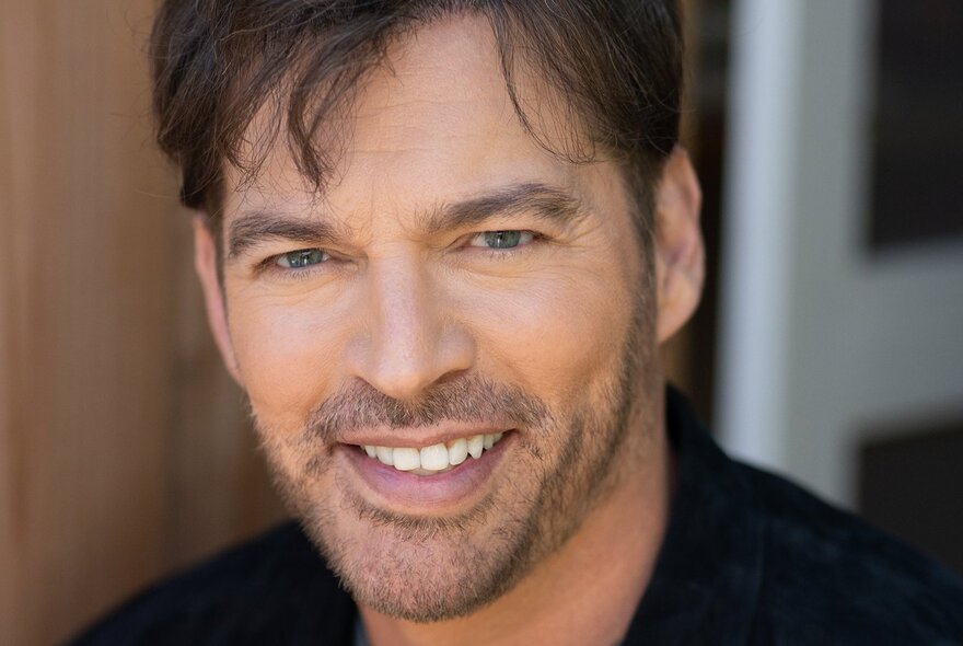 Portrait of the iconic, Harry Connick, Jr, smiling.