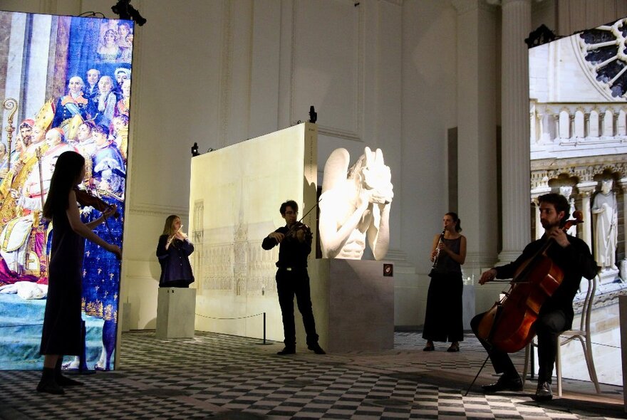 A string quintet playing in amongst the Notre-Dame display at the Melbourne Immigration Museum.