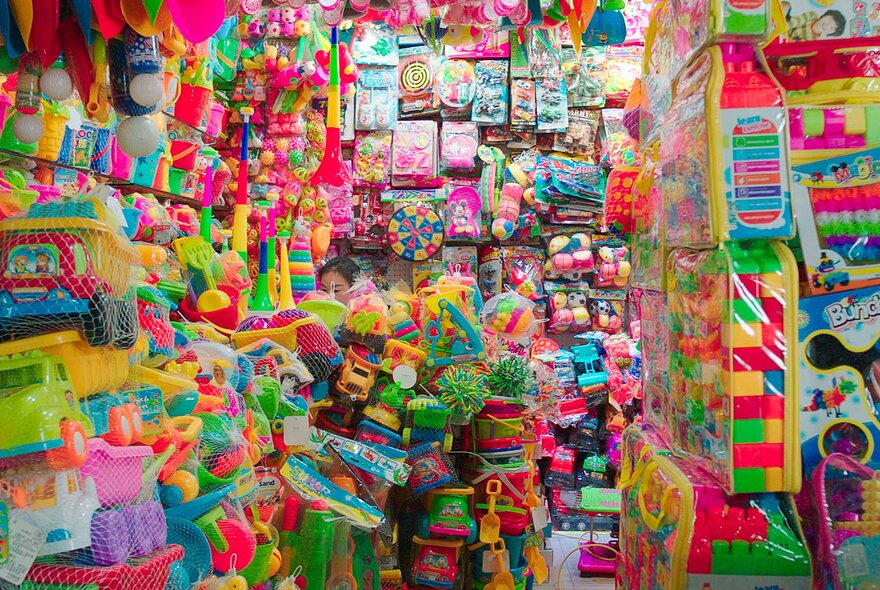 Inside a small shop filled with sparkly decorations and plastic novelty goods.