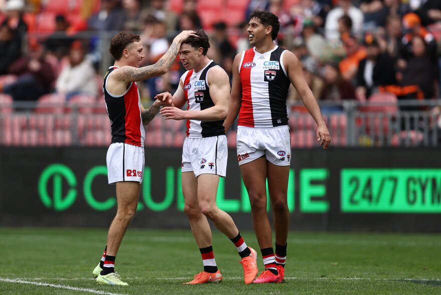 St Kilda AFL football players on the field during a match.
