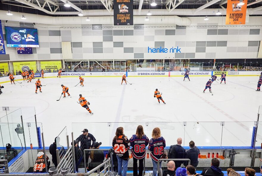 A busy ice hockey stadium with a game taking place