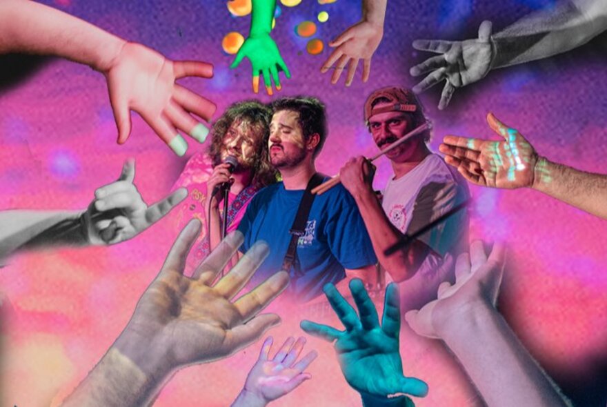 Three performers in the centre of a colourful image, surrounded by hands all pointing towards the central group.