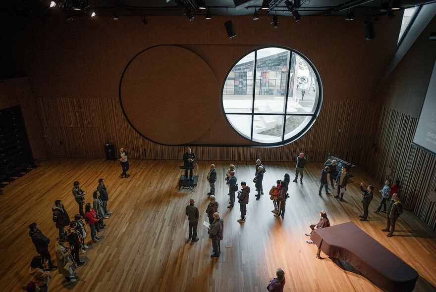 People gathered inside a an auditorium.