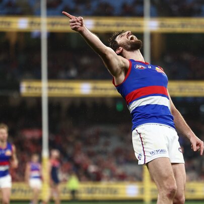 Bulldogs skipper Marcus Bontempelli celebrates a goal with his hand in the air. 
