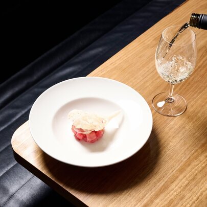 A dessert with a glass of white wine being poured.