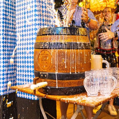 A traditional beer keg-tapping ceremony at an Oktoberfest celebration, at a Bavarian-style beer hall.