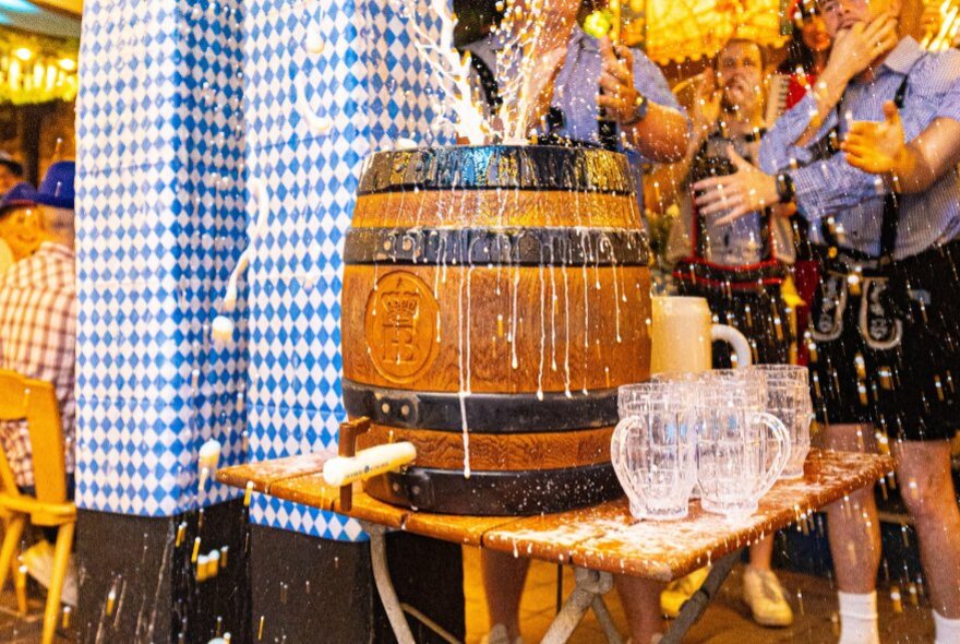 A traditional beer keg-tapping ceremony at an Oktoberfest celebration, at a Bavarian-style beer hall.