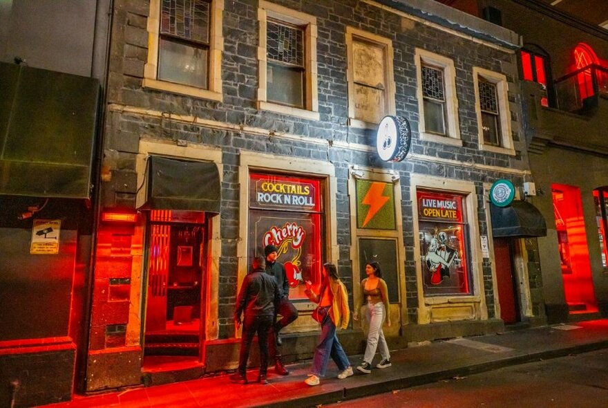 People outside Cherry Bar at night.